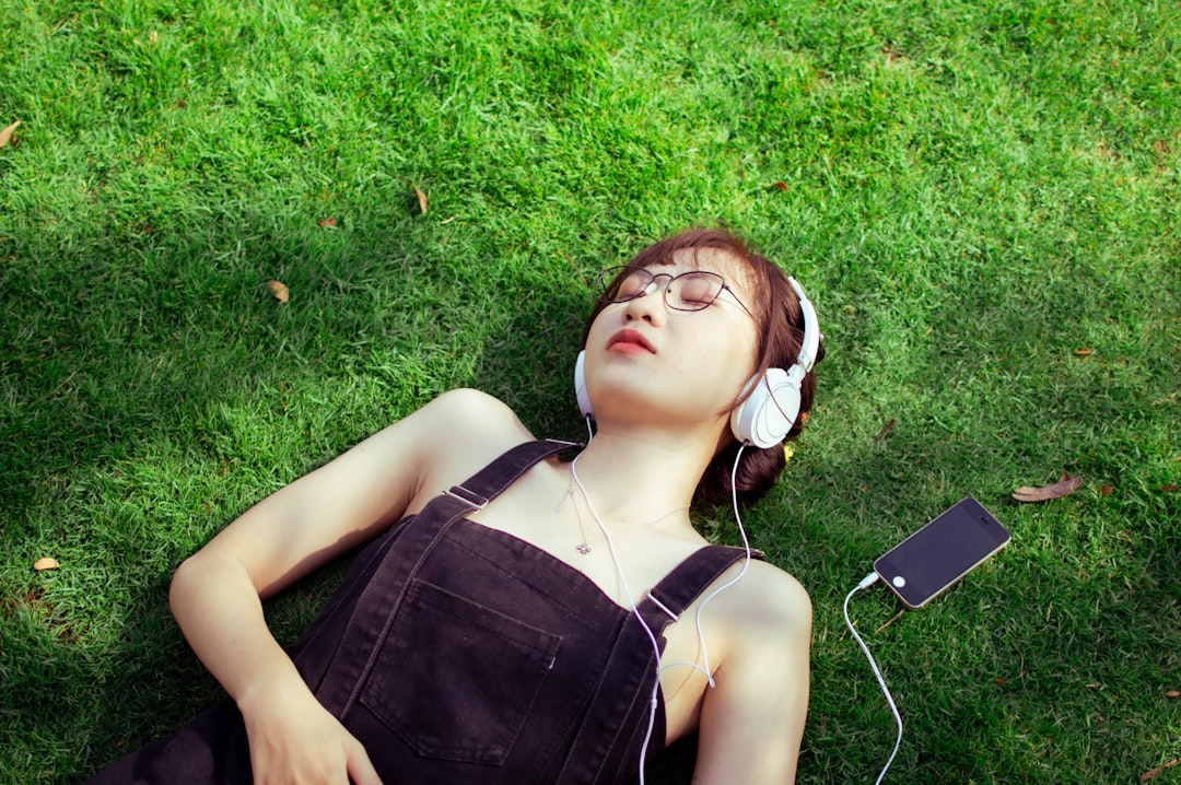 Lifestyle image showing a person outdoors using the Panasonic Portable CD Player SL-CT800, with head