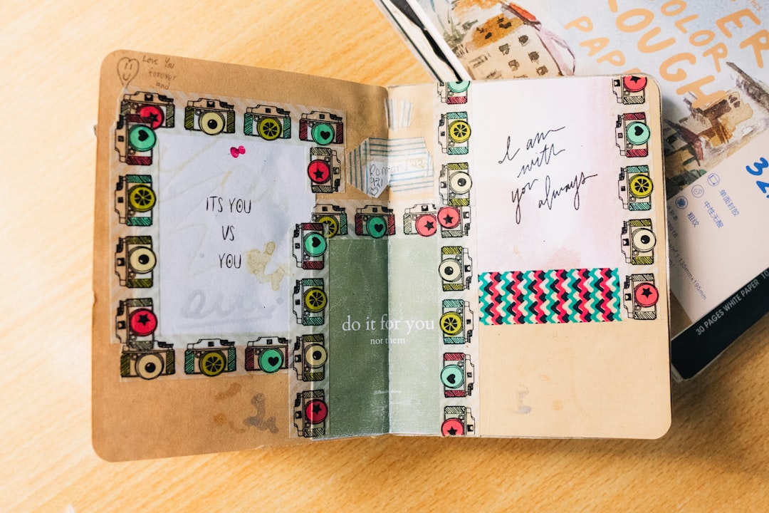 A creative art journaling spread showcasing layered washi tapes of different widths, mixed media ele