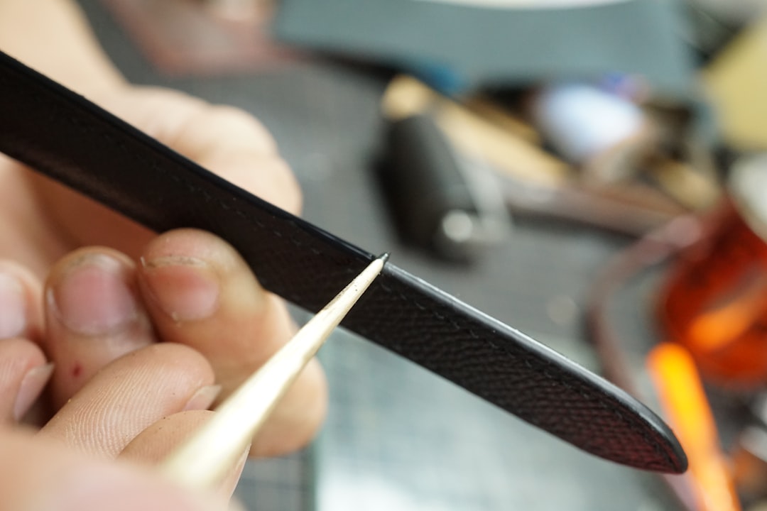 A high-resolution close-up image showing a Shun or Yoshihiro knife blade being sharpened on a water-