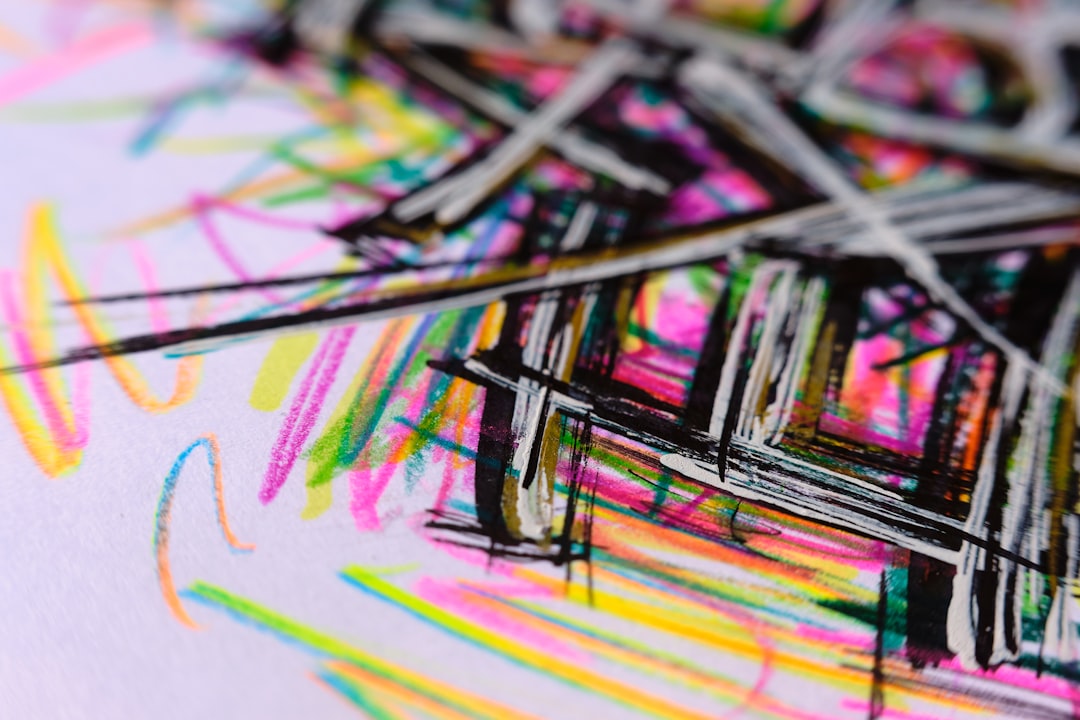 A vibrant, close-up image of a hand elegantly using a Tombow Dual Brush Pen to create colorful calli