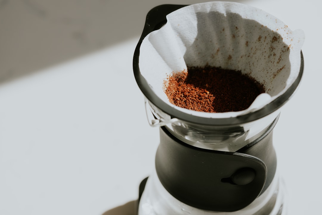Close-up image of the Hario V60 ceramic dripper with paper filter inside, showing the spiral ribs an