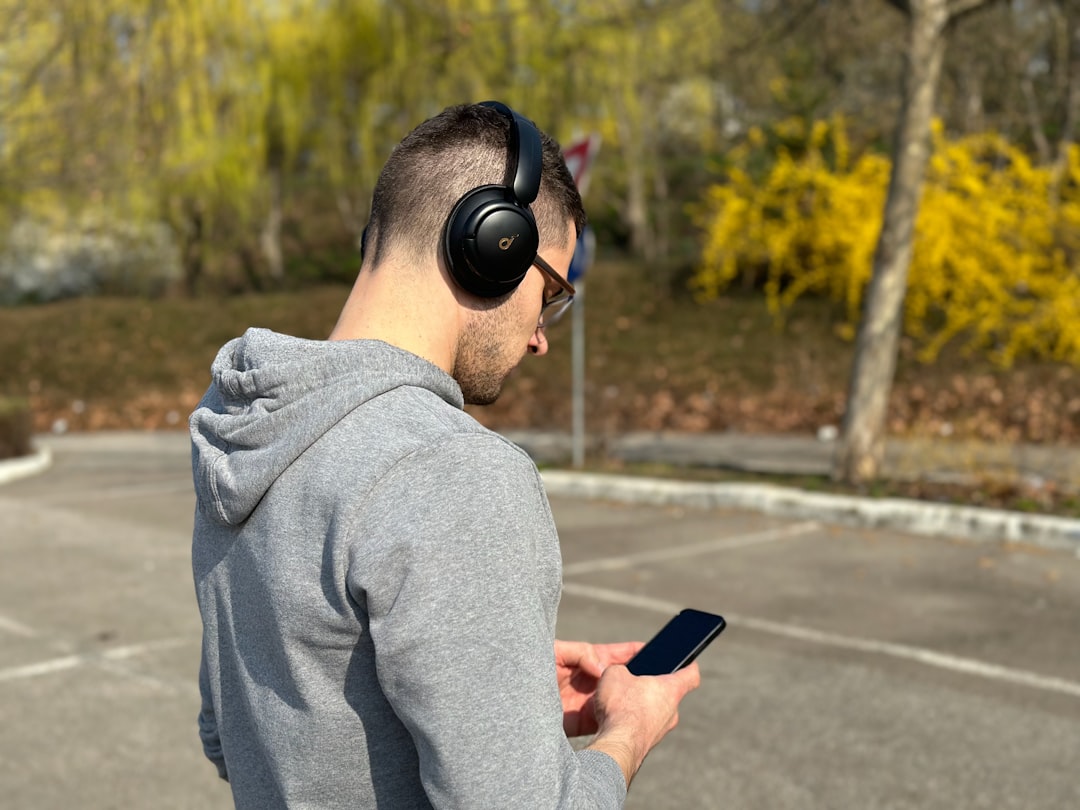 Lifestyle image of an active commuter wearing Panasonic RZ-S500W earbuds outdoors, e.g., walking or