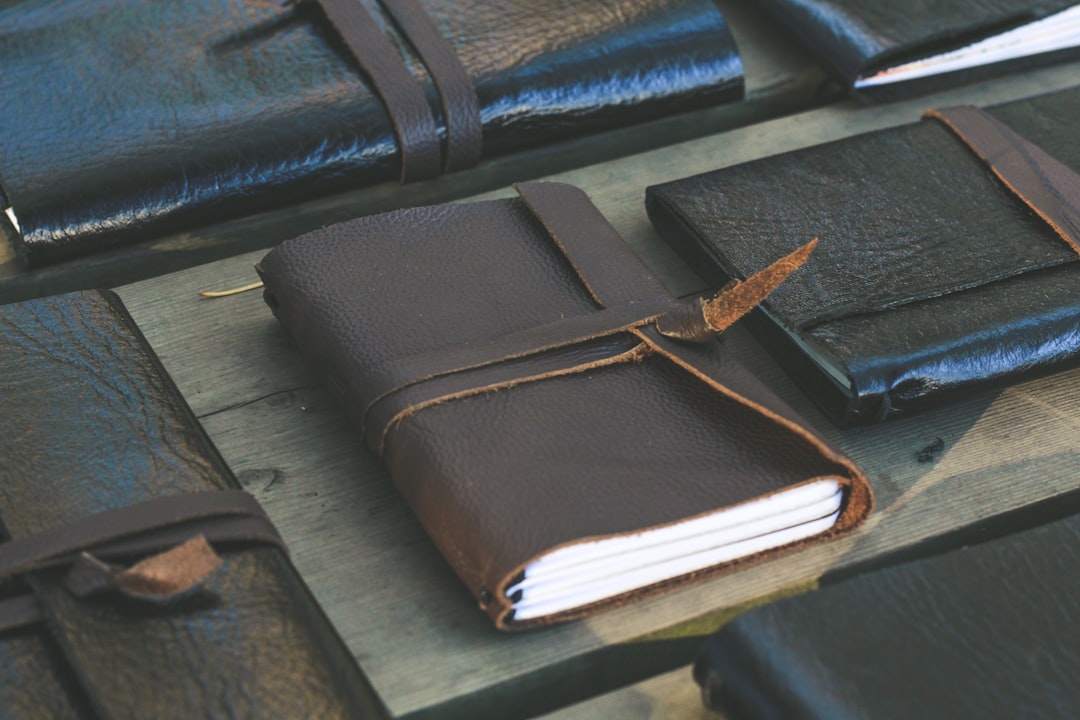 Lifestyle image featuring the Midori Traveler's Notebook open with multiple refill inserts visible,