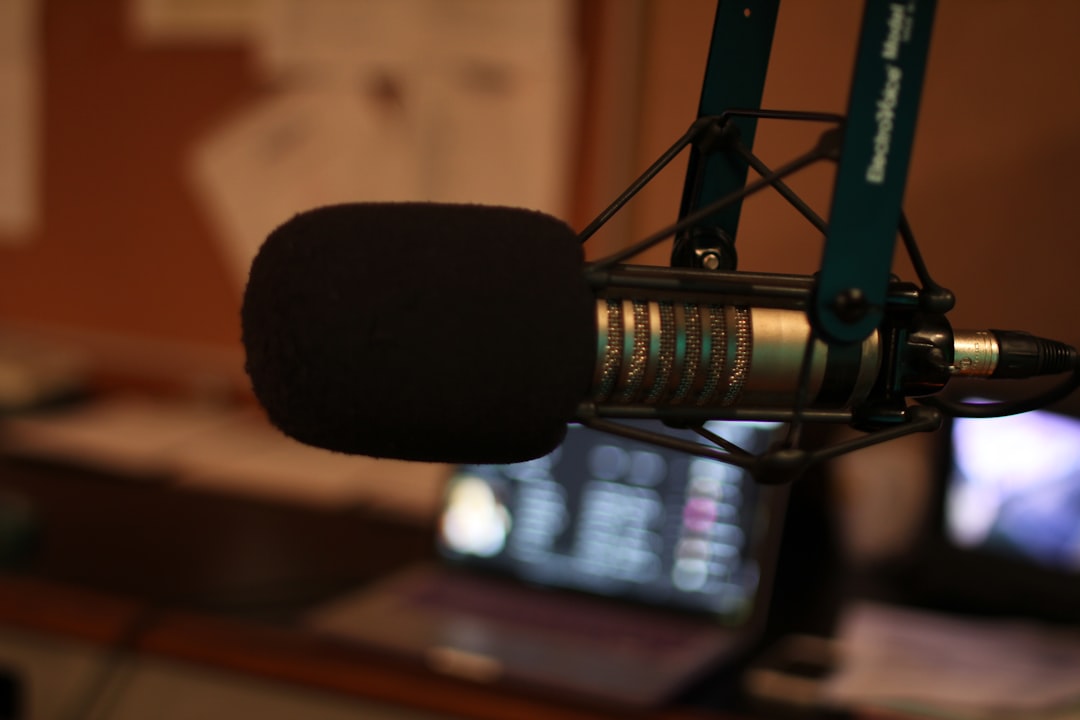 Image of a podcaster or musician using the AT2020 condenser microphone in a home studio setting. Thi