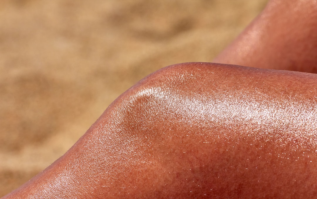 Close-up of hands dispensing Hada Labo UV Perfect Gel sunscreen, showing the gel texture and highlig