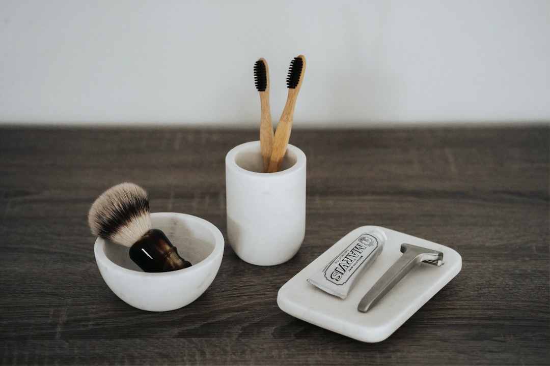 A clean, minimalist flat lay of Muji beauty tools arranged neatly on a neutral-toned background (e.g