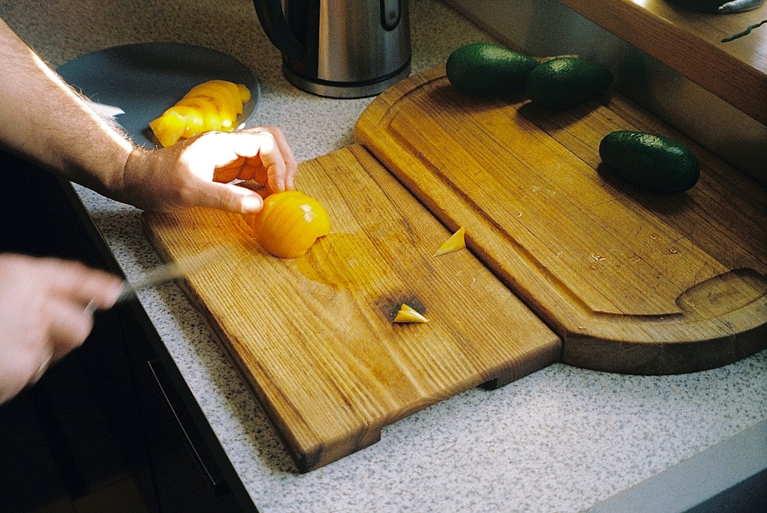 Lifestyle photo of an American home chef using the Miyabi Kaizen 7-Inch Santoku knife to chop fresh