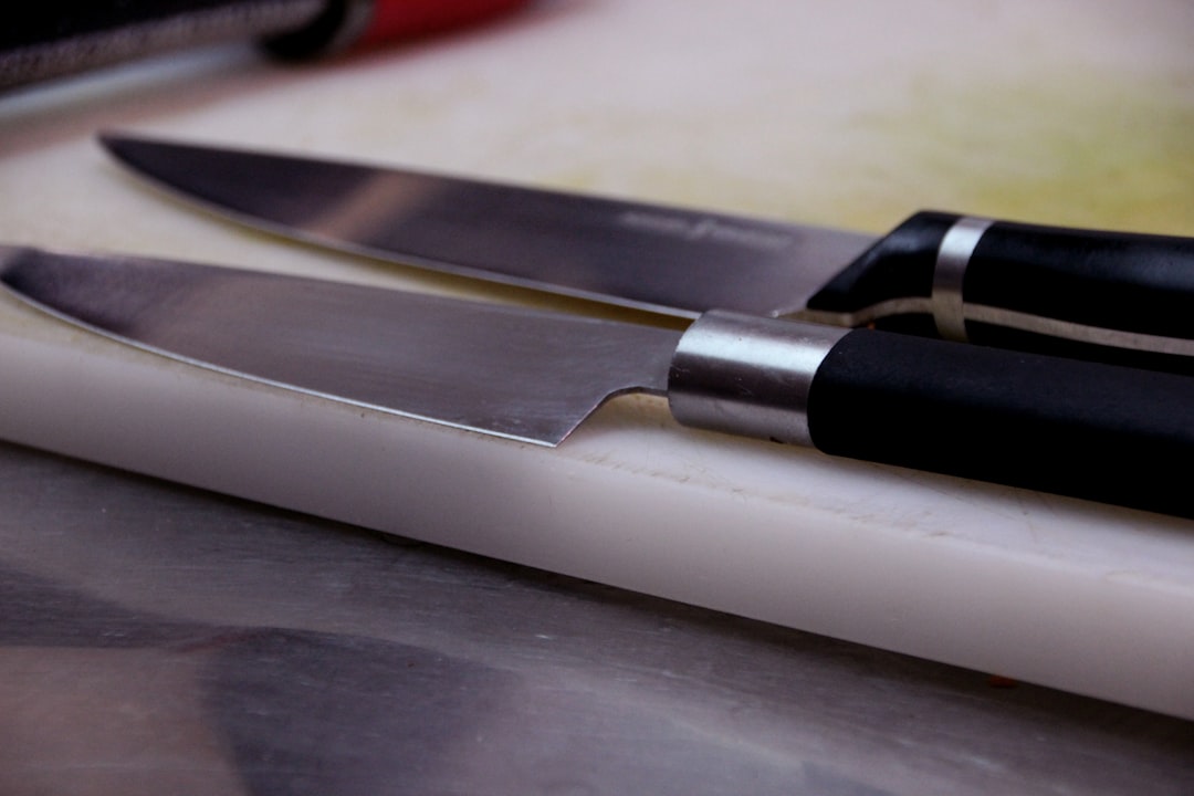 Side-by-side image comparing the Yoshihiro Blue Steel Gyuto 240mm carbon steel knife and the Shun Cl