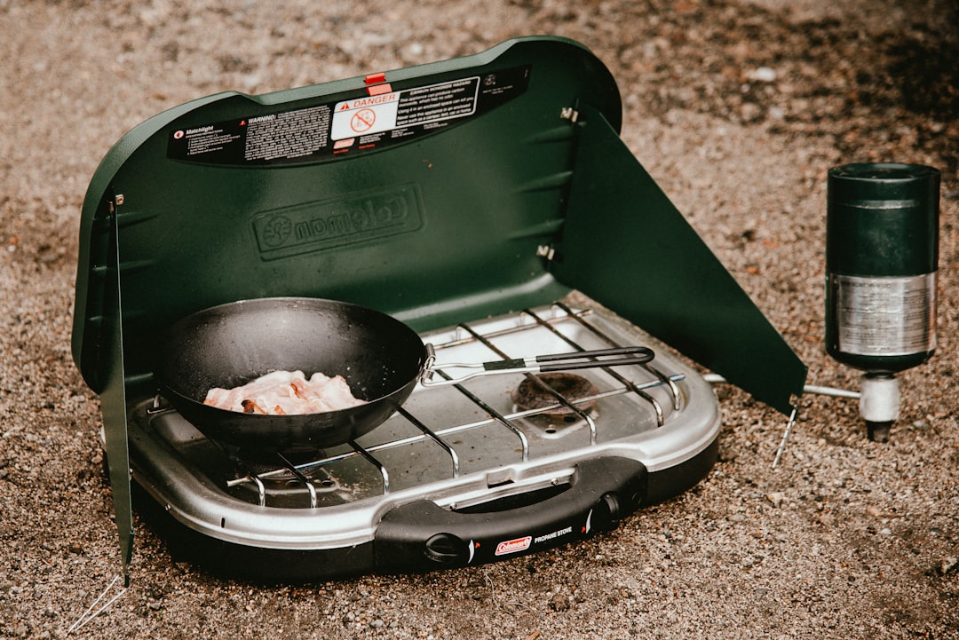 Image showing Snow Peak Titanium Multi Compact Cookset nested and packed inside a backpack and also 