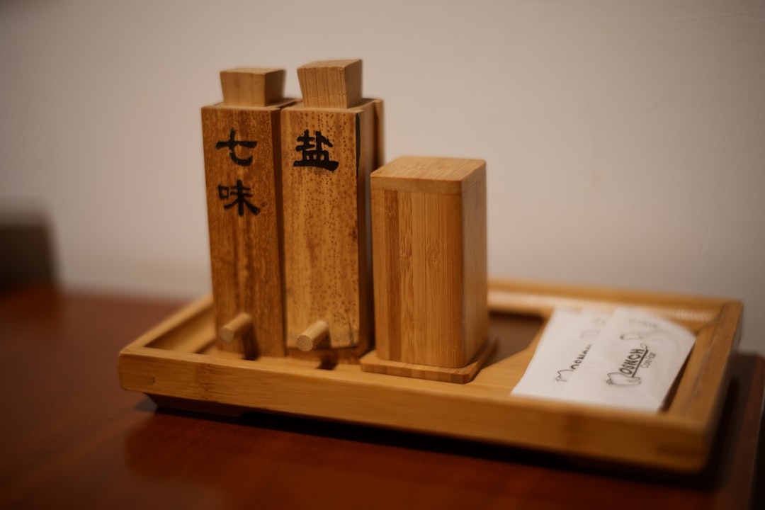 Photo showcasing the Hakoya wooden bento box with its natural wood grain, urushi lacquer finish, and
