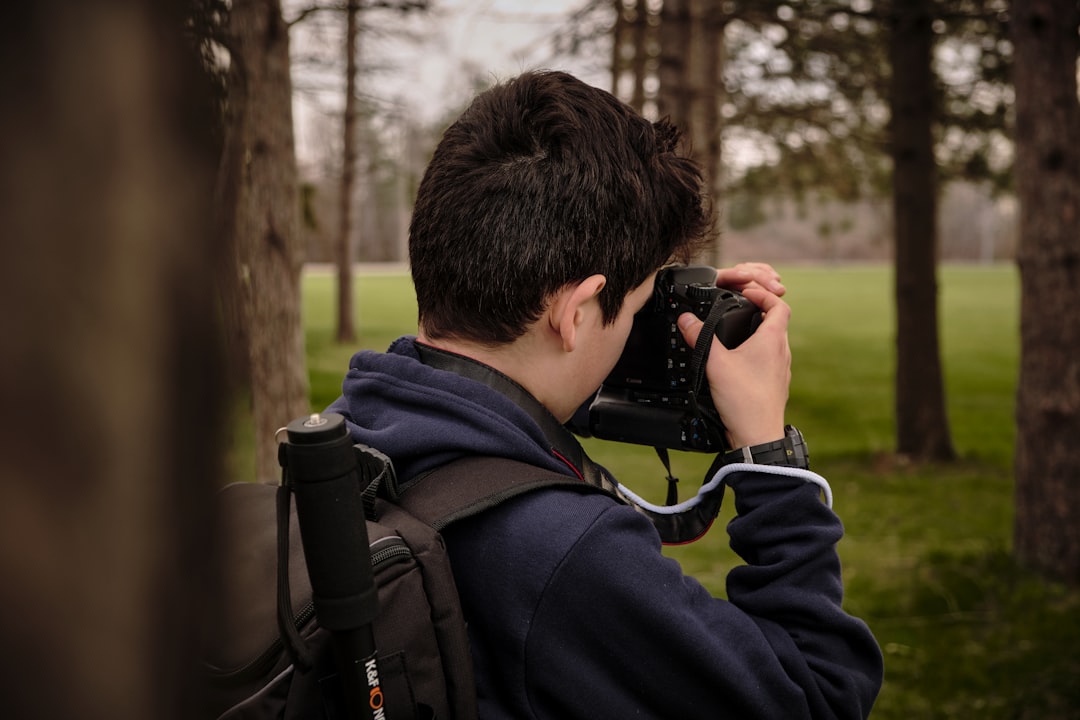 Photo of a professional photographer using a Fujifilm GFX medium format camera outdoors during a sho