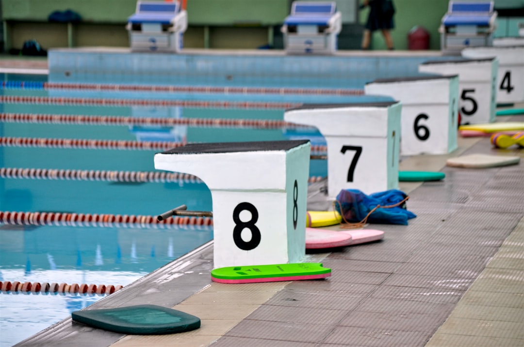 Image of a smartwatch submerged underwater or worn by a swimmer in a pool, showcasing water resistan