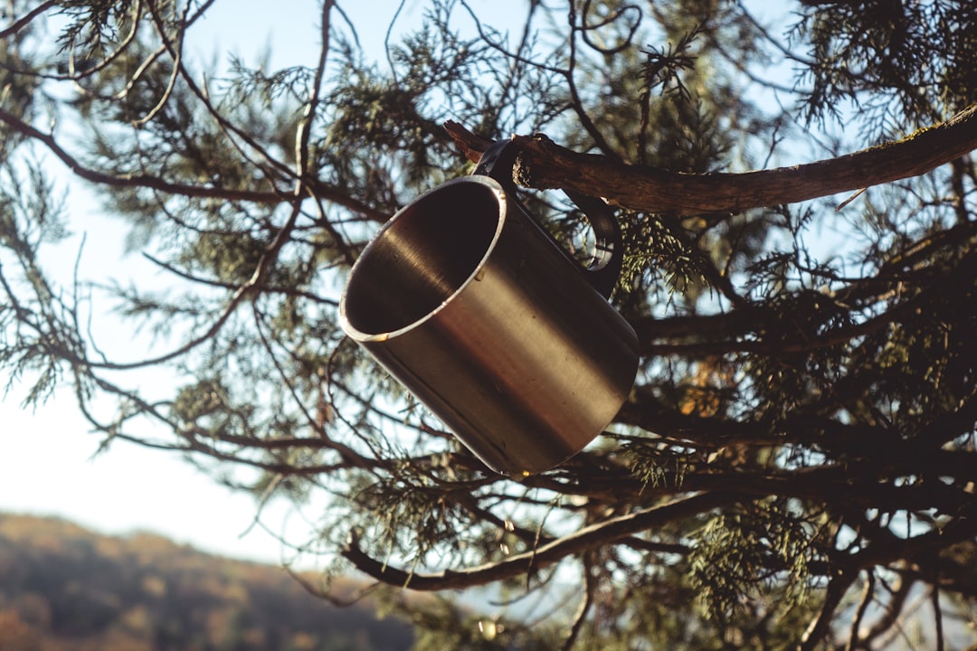 Image of a Japanese titanium cup nested inside a camping pot alongside other ultralight gear, illust