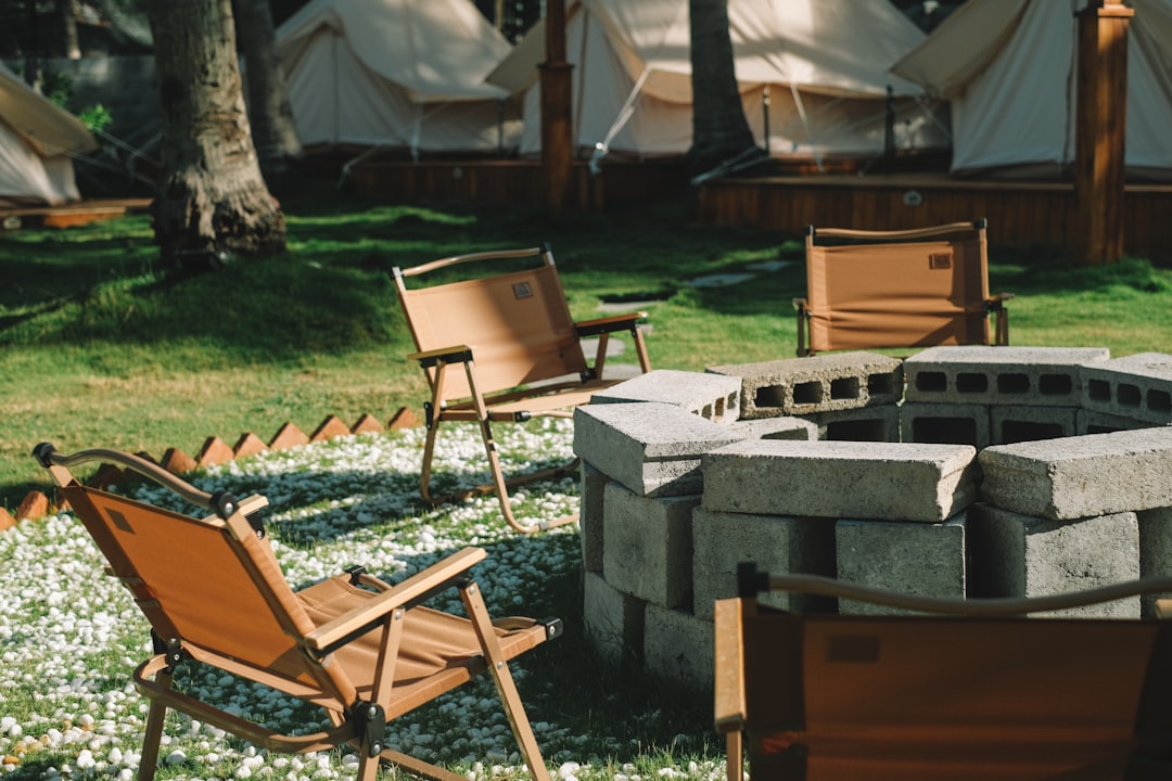 A side-by-side lifestyle image showing a Coleman Japan lightweight camping chair and aluminum table