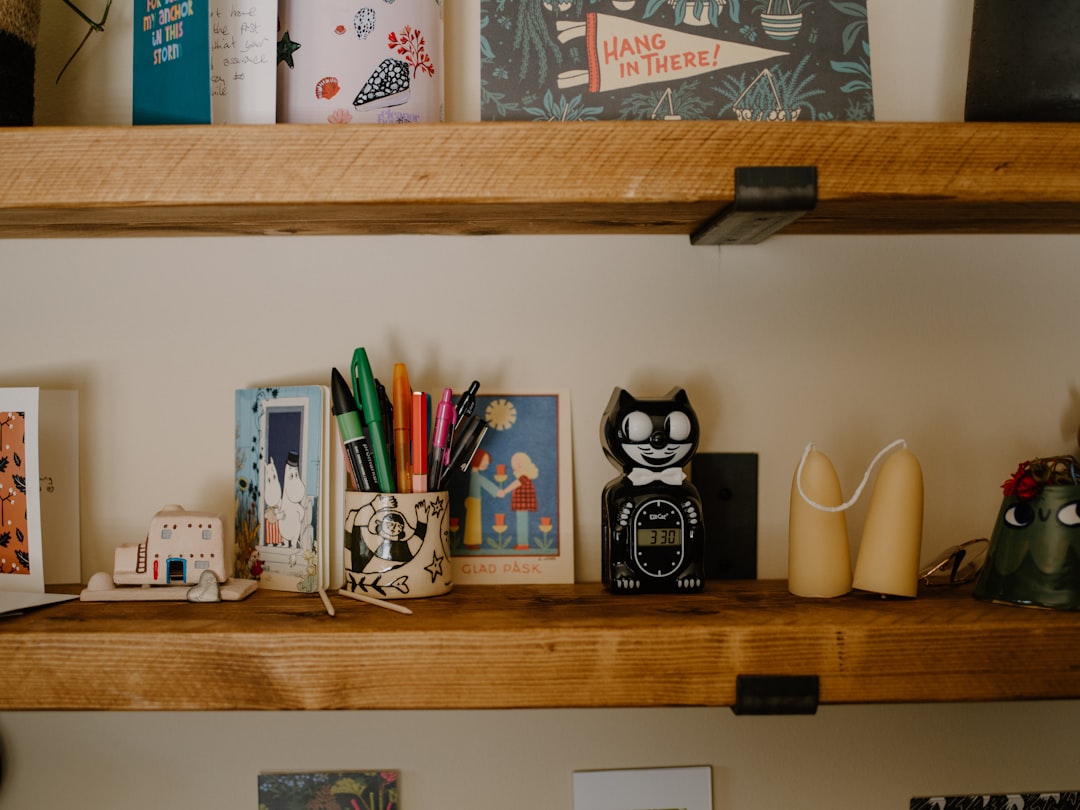 A staged photo showing a creative's desk with multiple pen cases assigned to different zones: one pe