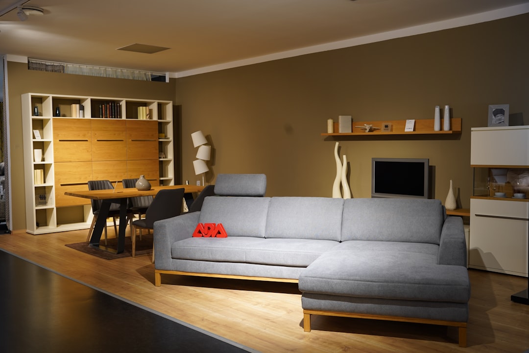 Image of a minimalist living room with a Denon soundbar positioned under a flat-screen TV, illustrat