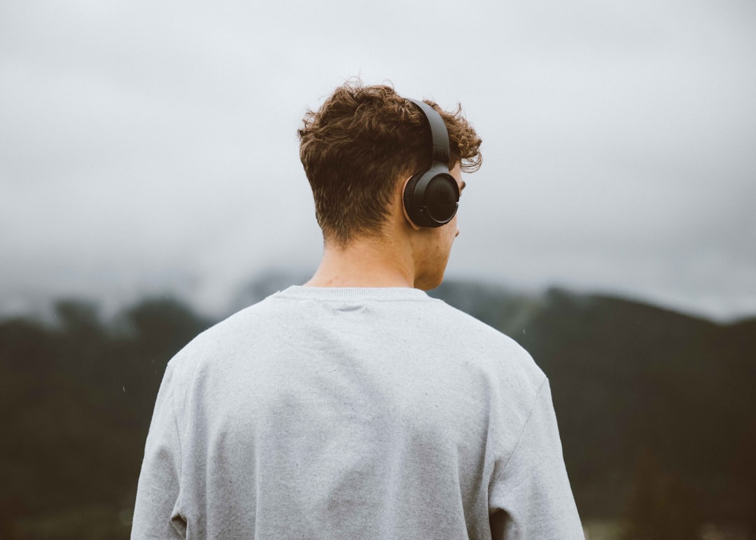 Hero image showing an American outdoor enthusiast (e.g., hiker or camper) wearing wireless headphone