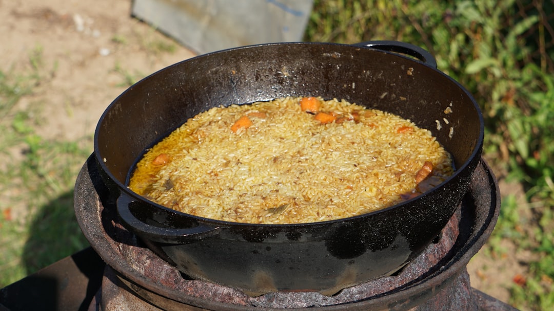 Close-up photo of a Zojirushi or Tiger rice cooker inner pot showing the thick non-stick ceramic or 