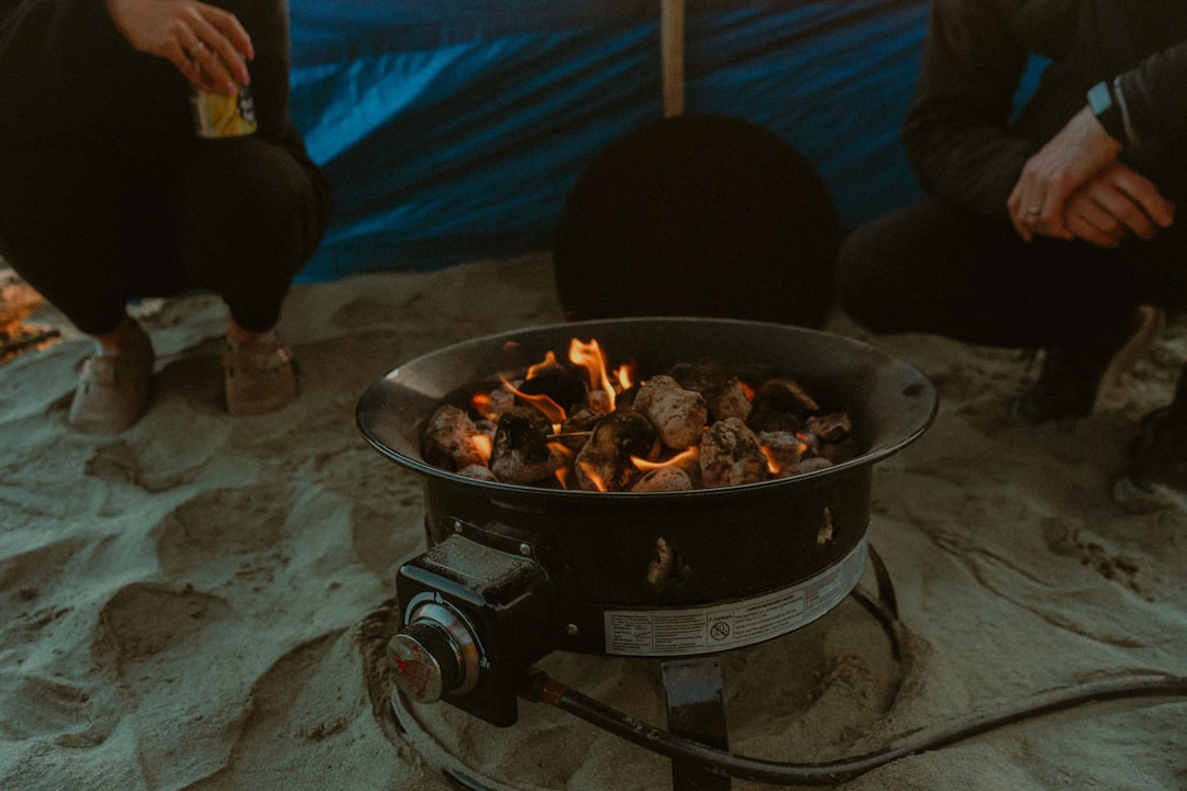 Hero image showing a scenic American camping spot with a campfire or portable stove setup featuring