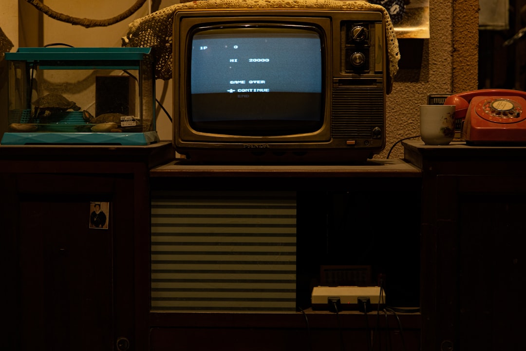 Photo of a user running Audyssey room calibration on a Marantz AV receiver using a microphone and TV