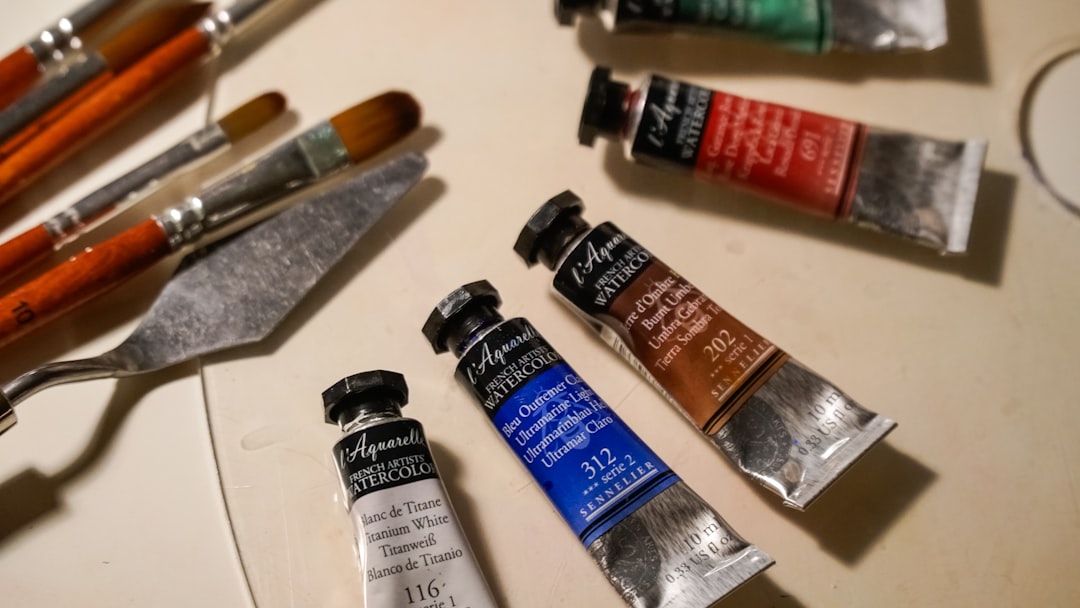 Lifestyle image of an artist's desk showing the Tombow Mono Sand Eraser alongside charcoal and paste