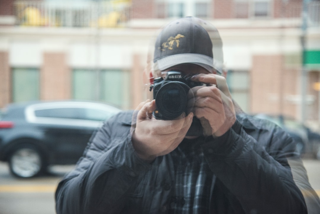 Lifestyle image showing a traveler vlogging or taking selfies with the Panasonic Lumix G100 featurin