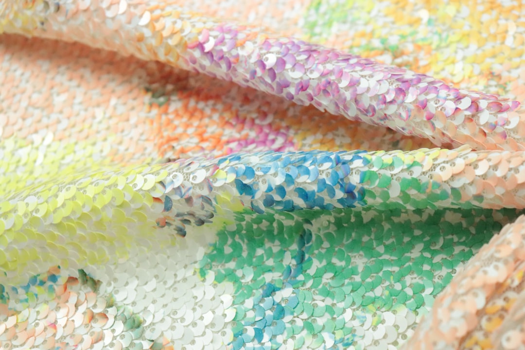 Close-up image of MT Masking Tape rolls showing their vibrant, diverse patterns with a hand tearing 