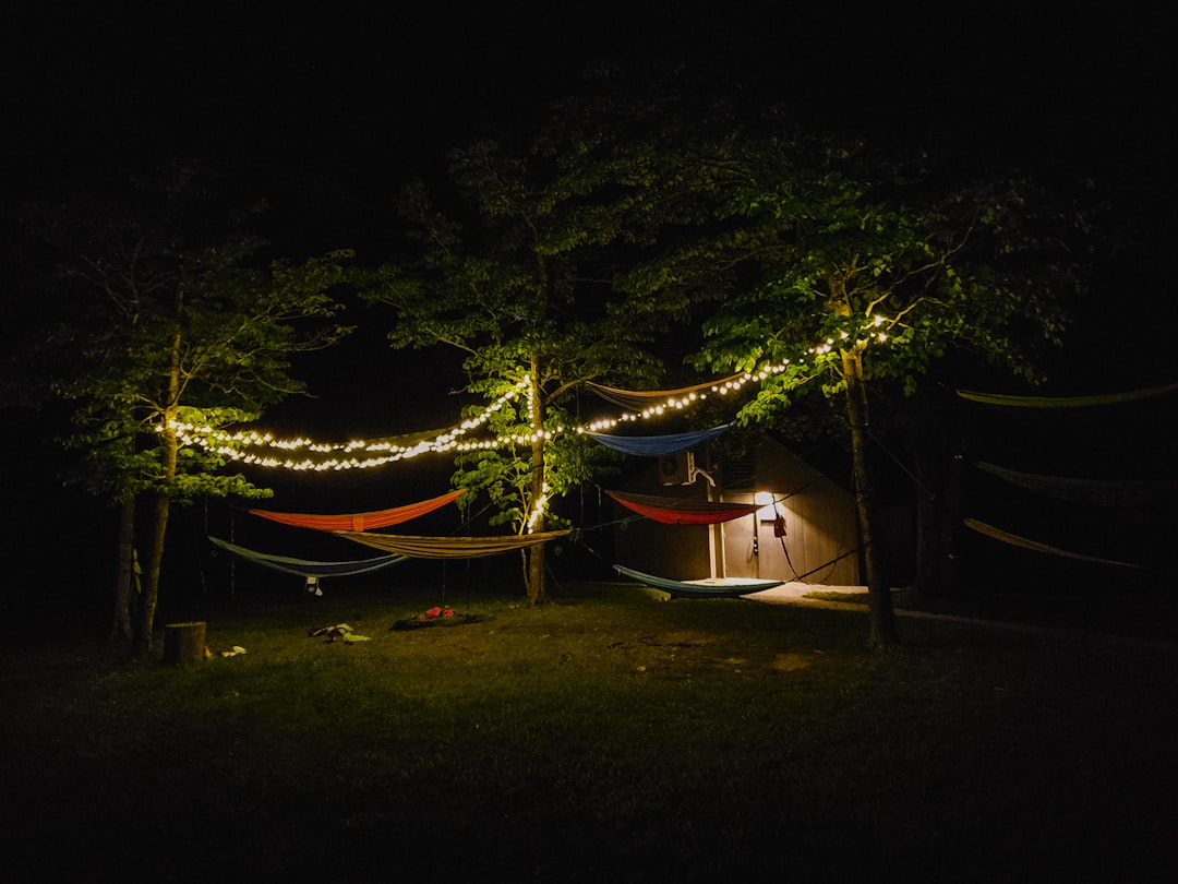 A serene outdoor campsite scene during golden hour featuring a minimalist Japanese camping setup. In