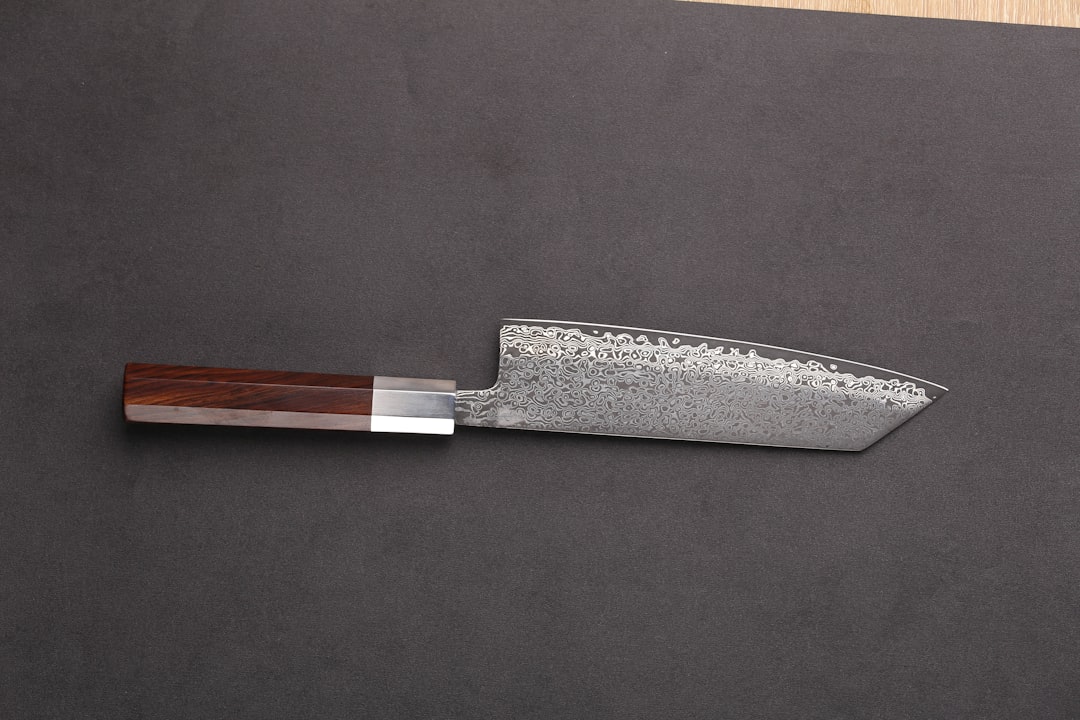 A close-up hero image showing a Shun or Yoshihiro knife edge being sharpened on a Japanese whetstone