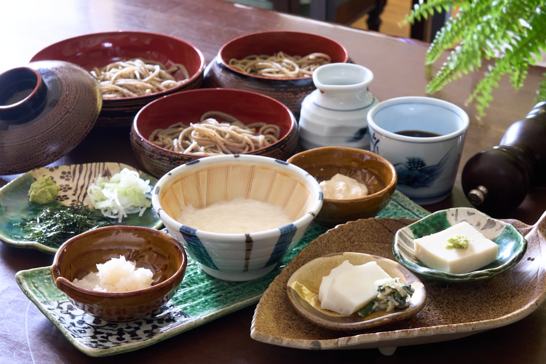 A warm, inviting kitchen scene featuring both a Zojirushi and a Tiger rice cooker prominently displa