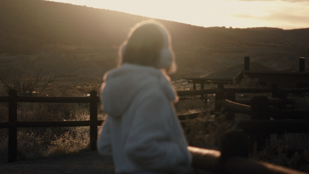 A high-quality hero image showing a person outdoors in a scenic Japanese mountain setting wearing wi