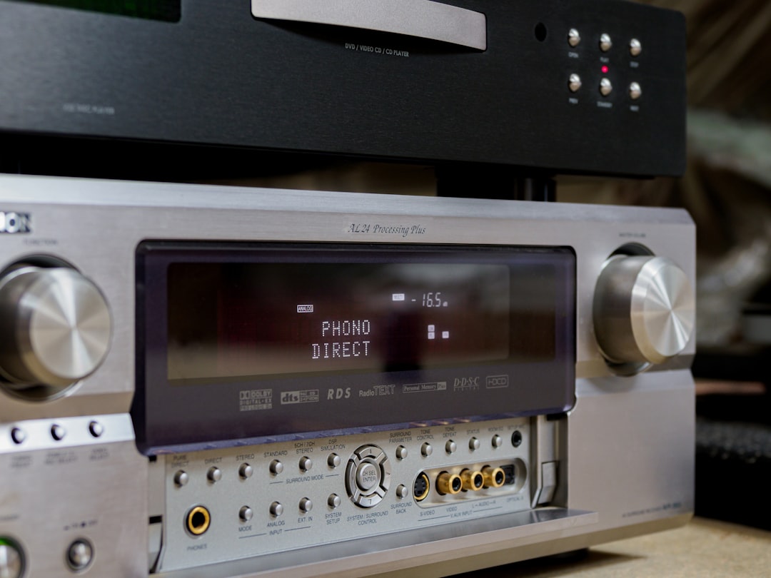 A high-quality hero image featuring a sleek Denon or Marantz receiver prominently displayed in a sty