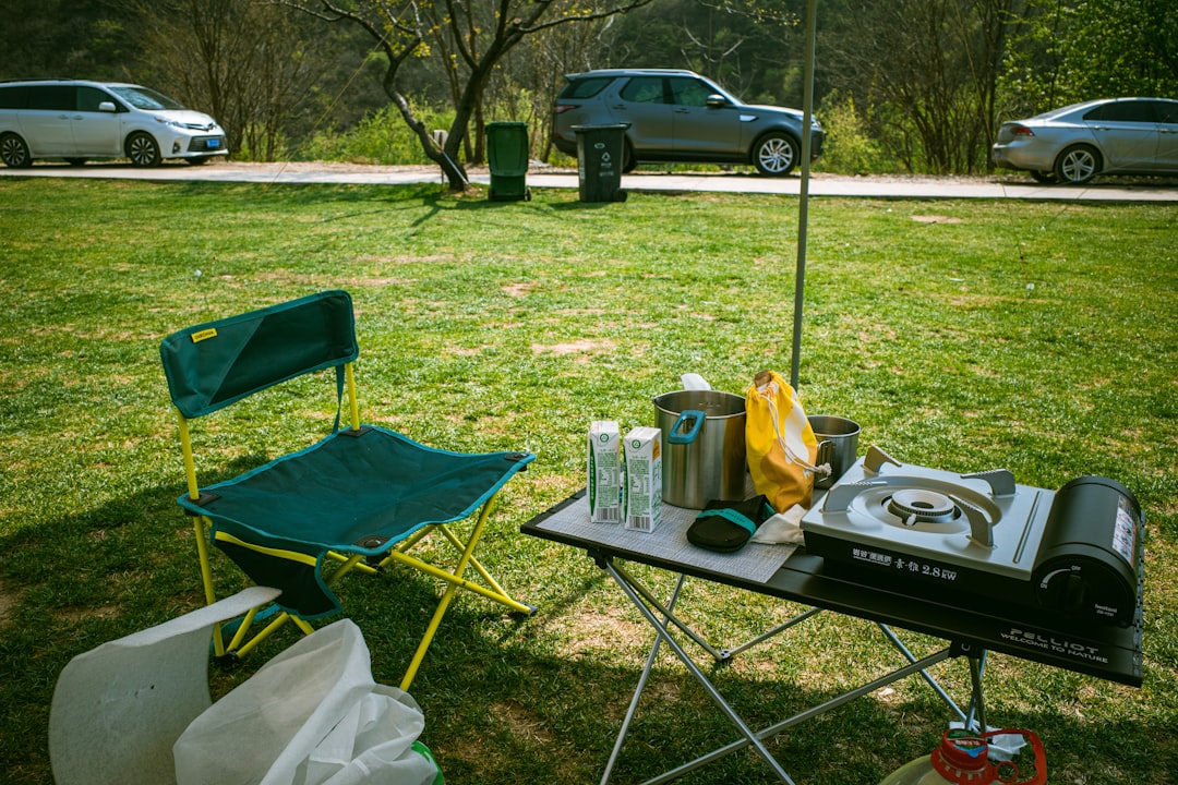 Outdoor scene featuring the rugged Snow Peak Field Planner placed on a camping table alongside gear 
