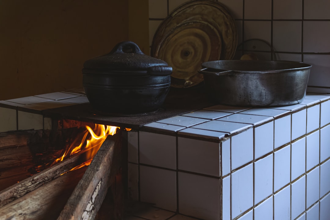 A beautifully styled hero image showing a Tiger cast iron Dutch oven and grill pan arranged on a rus